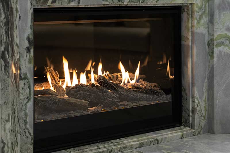 Burning Gas Fireplace Built into Marble